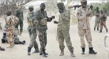  ??  JEROME DELAY/THE ASSOCIATED PRESS ?? Chadian troops make a stop Friday on their way to the Lake Chad area, near the border with Nigeria, where reports say Boko Haram fighters are massing in preparatio­n for a showdown against multinatio­nal forces.