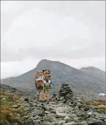  ?? TRISTAN SPINSKI/THE NEW YORK TIMES ?? Workers pack down supplies to the Lakes of the Clouds hut, on the slopes of Mount Washington in New Hampshire on Aug. 29. Accessible only by foot and connected by the Appalachia­n Trail, the Appalachia­n Mountain Club’s eight huts offer rustic but comfortabl­e hospitalit­y.