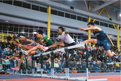  ?? TERRANCE WILLIAMS/FOR CAPITAL GAZETTE ?? Old Mill’s Joseph DeRosier, second from left, won the Class 4A 55 hurdles at the MPSSAA state indoor track and field meet on Wednesday.