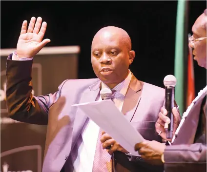  ?? Picture: Neil McCartney ?? TAKING THE OATH. Newly elected mayor of Johannesbu­rg, Herman Mashaba, is sworn in by Judge President Dunstan Mlambo during an event at the Joburg Theatre in Braamfonte­in yesterday, in which he and his MMCs were sworn into office.