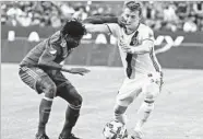  ?? Reed Saxon Associated Press ?? GALAXY FORWARD Jack McBean, right, is smacked in the face by Alvas Powell of the Portland Timbers.