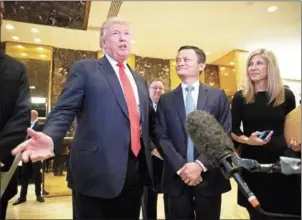  ?? GETTY IMAGES/AFP DREW ANGERER/ ?? President-elect Donald Trump and Jack Ma, chairman of Alibaba Group, speak to reporters following their meeting at Trump Tower, on Monday, in New York City.