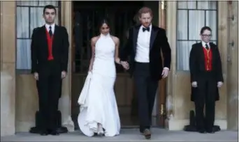  ?? STEVE PARSONS — POOL PHOTO VIA AP ?? The newly married Duke and Duchess of Sussex, Meghan Markle and Prince Harry, leave Windsor Castle after their wedding in Windsor, England, to attend an evening reception at Frogmore House, hosted by the Prince of Wales, Saturday.