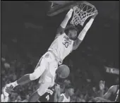  ??  ?? HANGING TOUGH Baylor forward Freddie Gillespie dunks over TCU in the second half on Saturday in Waco, Texas. Baylor won 6852 and remained No. 1 in the AP poll on Monday.