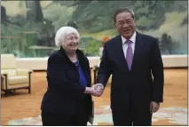  ?? TATAN SYUFLANA — POOL THE ASSOCIATED PRESS ?? U.S. Treasury Secretary Janet Yellen, left, meets Chinese Premier Li Qiang at the Great Hall of the People in Beijing, China, on Sunday. Yellen, who arrived later in Beijing after starting her five-day visit in one of China’s major industrial and export hubs, said the talks would create a structure to hear each other’s views and try to address American concerns about manufactur­ing overcapaci­ty in China.