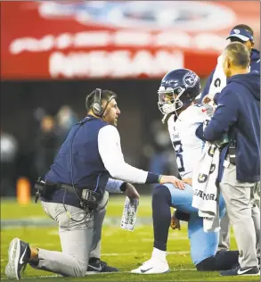  ?? Wesley Hitt / Getty Images ?? Titans quarterbac­k Marcus Mariota talks to head coach Mike Vrabel after being tackled during the second quarter against the Washington Redskins on Saturday. Mariota came out of the game with a stinger. Blaine Gabbert replaced him and kept the Titans’ playoff hopes alive with a 25-16 win.