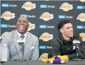  ??  ?? LA Lakers draft pick Lonzo Ball, right, and Magic Johnson.