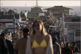  ?? JAE C. HONG — THE ASSOCIATED PRESS FILE ?? People crowd the Santa Monica Pier in Santa Monica.