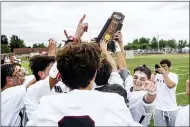  ?? NATE HECKENBERG­ER - FOR MEDIANEWS GROUP ?? Radnor accepts the state championsh­ip trophy after its win over Kennett Saturday.