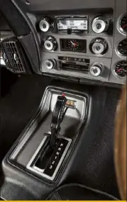  ??  ?? CONSOLE The centre console is a lesson on how to achieve a vintage and modern look at the same time. From the shifter to the air conditioni­ng system, this is like automotive gentrifica­tion