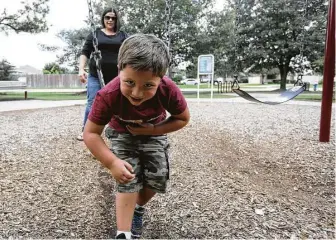  ?? Elizabeth Conley / Houston Chronicle ?? Lezlie Walla had to put off taking her son, Caleb, to the doctor because of her high deductible.