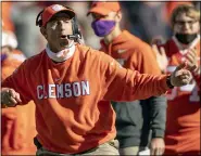  ?? JOSH MORGAN — POOL PHOTO VIA AP, FILE ?? In this Oct. 31, 2020, file photo, Clemson head coach Dabo Swinney talks with players during the second half of an NCAA college football game against Boston College, Saturday, Oct. 31, 2020, in Clemson, S.C. Swinney, the coach of No. 3 Clemson, faces No. 5 Georgia in the seasonopen­er in Charlotte, N.C.