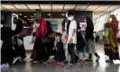  ??  ?? Refugees from Afghanista­n are escorted to a waiting bus after arriving at Dulles internatio­nal airport in Virginia, US. Photograph: Andrew Caballero-Reynolds/AFP/ Getty Images