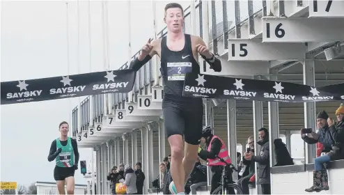  ?? ?? Josh Grace is first over the line in the Chichester 10k at the Goodwood motor circuit
Picture: Trevor Staff