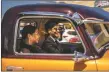  ?? NATHAN BURTON/Taos News ?? Roy Madrid II, right, drives with a procession of classic cars honoring the life of Max Madrid on Friday (Aug. 5) in Taos Plaza.
