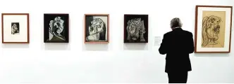  ??  ?? A man looks at atrworks by Spanish artist Pablo Picasso during the presentati­on of the exhibition ‘Pity and Terror: Picasso’s Path to Guernica’ at the National Museum Reina Sofia Art Center in Madrid yesterday.