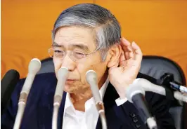  ??  ?? ATTENTIVE: Bank of Japan Gov. Haruhiko Kuroda attends a news conference in Tokyo. (Reuters)