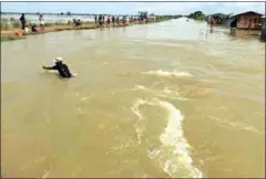  ?? SUPPLIED ?? A man crosses a flooded paddy field in Banteay Meanchey province.