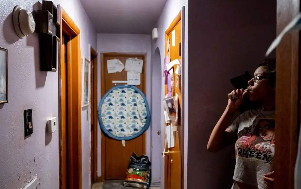  ??  ?? Vanessa Peoples smokes a joint in the hallway of her family home, where in 2017 she was injured by Aurora police. For Peoples, marijuana, which she uses only when her kids aren’t around, is one of the few things that relieves her stress, depression and anxiety. She says walking through that hallway every day forces her to think about the worst day of her life.