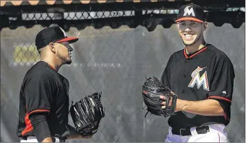  ?? BILL INGRAM / PALM BEACH POST ?? Jose Fernandez (right), the Marlins pitching ace who was killed in a boating accident last season, talks with teammate A.J. Ramos on a Roger Dean Stadium field in Jupiter during spring training three years ago.