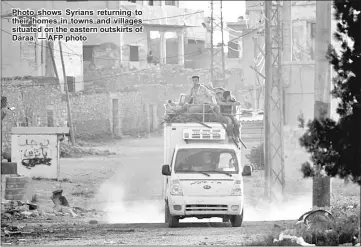  ??  ?? Photo shows Syrians returning to their homes in towns and villages situated on the eastern outskirts of Daraa. — AFP photo