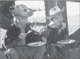  ?? Calgary Herald Archive ?? Matthew Ferguson, 7, and his sister Emma, 4, enjoyed breakfast as they watched the entertainm­ent at the Herald-sponsored pancake breakfast at Chinook Centre in 1996.