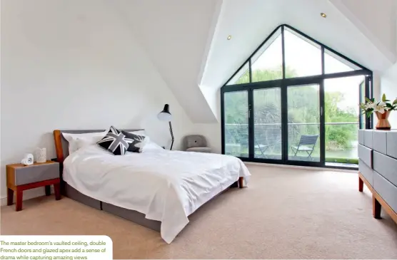  ??  ?? The master bedroom’s vaulted ceiling, double French doors and glazed apex add a sense of drama while capturing amazing views