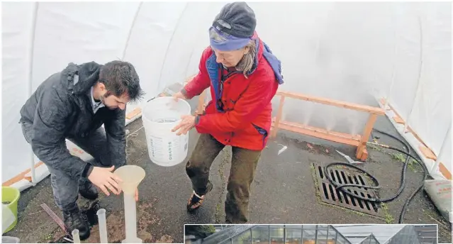  ??  ?? At work: University of Washington faculty member Susan Bolton and student Peter Cromwell measure the amount of water collected in 45 minutes.