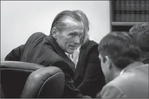  ?? AP/SCOTT SOMMERDORF ?? greets his defense team Saturday in a Utah courtroom just before a jury convicted him of murder and obstructio­n of justice.