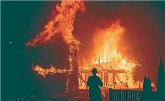  ?? AP ?? A home burns as the Camp Fire rages through Paradise.