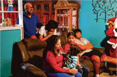  ?? ?? Juan Murillo and Sonia Montes spend time with some of their children, from left, Tadedo, 1; Carlos, 14; Sonia, 10; and Joshua, 18, at their home in Fairfield. When Murillo lost his job, the family fell behind on bills.