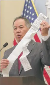  ?? RICH PEDRONCELL­I/AP ?? California Assemblyma­n Phil Ting, D-San Francisco, displays a long paper receipt as he discusses his bill to require businesses to offer electronic receipts on Tuesday.