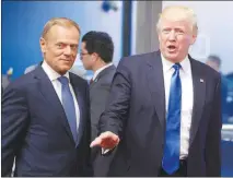  ?? OLIVIER MATTHYS / AP FILE (2017) ?? President Donald Trump, f lanked by European Council President Donald Tusk, speaks during a May 2017 visit to Brussels. Economists question whether the president’s proposed tariffs on aluminum and steel imports will do much to narrow the trade deficit,...