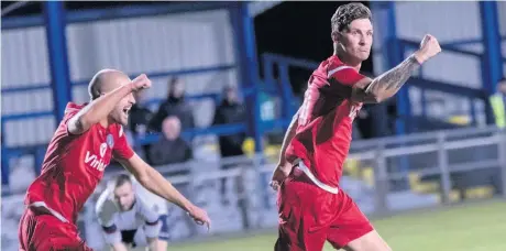  ?? Paul Watson/FJA Photograph­y ?? Skipper Simon Thelwell (right) celebrates one of his two goals for Runcorn Town against Vauxhall Motors last Friday evening with teammate Shaun Weaver in pursuit.