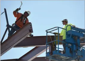  ?? RECORDER PHOTO BY CHIEKO HARA ?? Workers continue with the constructi­on of a 2-story classroom Tuesday despite soaring temperatur­es.