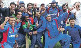  ??  ?? Afghanista­n players and officials celebrate after beating UAE in 2010