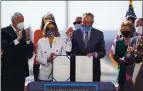  ?? STEFANI REYNOLDS — THE NEW YORK TIMES ?? House Speaker Nancy Pelosi and Senate Majority Leader Chuck Schumer pose with the signed COVID-19 relief bill outside the Capitol Wednesday.