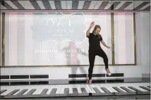  ?? MARY ALTAFFER / ASSOCIATED PRESS ?? An employee plays the FAO Premium Piano Dance Mat during Tuesday’s media preview of the new FAO Schwarz store in New York. Replicas for sale cost $128.