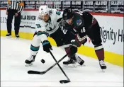  ?? RICK SCUTERI — THE ASSOCIATED PRESS ?? Sharks defenseman Radim Simek, left, battles for the puck against Arizona Coyotes center Derick Brassard.