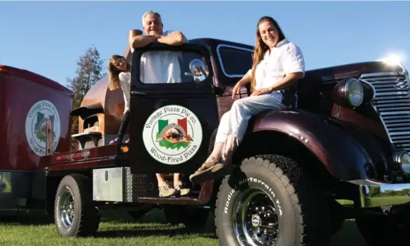  ?? CAROLA VYHNAK FOR THE TORONTO STAR ?? A 1938 Chevy Maple Leaf flatbed truck, outfitted with an oven, is the main transporta­tion for Richard Clarke and Isabelle Boisvert’s mobile pizza-making business. Daughter Kyra, 7, looks on.