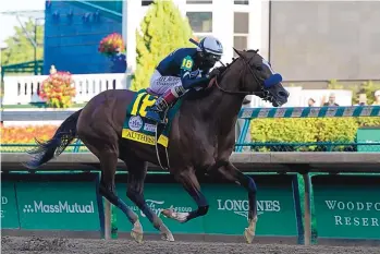  ?? DARRON CUMMINGS/ASSOCIATED PRESS ?? Jockey John Velazquez rides Authentic heads to the finish line to win the 146th running of the Kentucky Derby at Churchill Downs in Louisville, Ky. Authentic upset heavy favorite Tiz the Law.