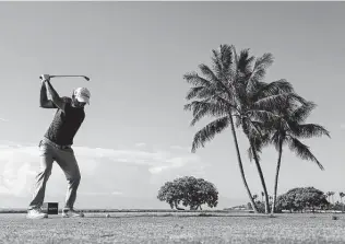  ?? Gregory Shamus / Getty Images ?? Russell Henley plays his shot from the 17th tee during the second round of the PGA Tour’s Sony Open at Waialae Country Club in Honolulu on Friday.