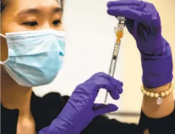  ?? SAM HODGSON U-T ?? Resident Nurse Tonia Yu prepares doses of the Pfizer vaccine at Scripps Memorial Hospital La Jolla.