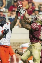  ?? MARKWALLHE­ISER — THE ASSOCIATED PRESS ?? Florida State defensive back Derwin James, right, breaks up a Syracuse pass intended for Steve Ishmael during Saturday’s game in Tallahasse­e, Fla.