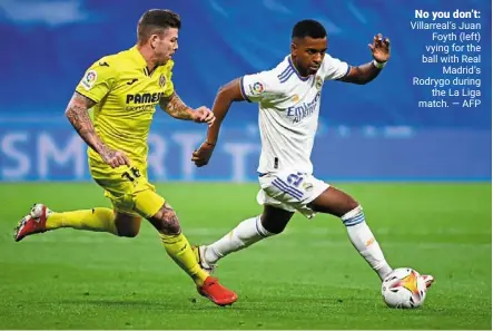  ?? — afp ?? No you don’t: Villarreal’s Juan Foyth (left) vying for the ball with real Madrid’s rodrygo during the La Liga match.