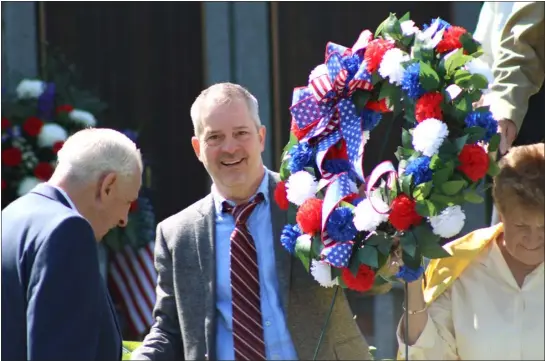  ?? CAMERON MORSBERGER — LOWELL SUN ?? Lowell Director of Veterans’ Services Eric Lamarche carries a commemorat­ive wreath he later placed at the Centralvil­le Memorial Park in Lowell on Memorial Day, May 29, 2023. Lamarche, who served in the U.S. Navy, helped organize the service as a member of the Centralvil­le Veterans Memorial Committee.