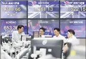  ??  ?? Currency traders work at the foreign exchange dealing room of the KEB Hana Bank headquarte­rs in Seoul, South Korea
on Oct 17, 2019. Asian shares were mixed Thursday after officials signaled work
remains to be done on an agreement for a truce in the tariff war between the US and
China. (AP)