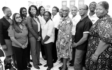  ?? PHOTOGRAPH­ER RUDOLPH BROWN/ ?? Denise Antonio (fifth right), UNDP resident representa­tive for Jamaica; and Gillian Guthrie (fourth left), acting chief technical director of the Policy, Planning and Evaluation Division in the Ministry of Economic Growth and Job Creation, pose with the seven grant beneficiar­ies who were given a boost to advance environmen­tal protection and resilience among vulnerable communitie­s in Jamaica. The event was held at the Ministry of Economic Growth and Job Creation’s Half-Way Tree Road offices last Tuesday.