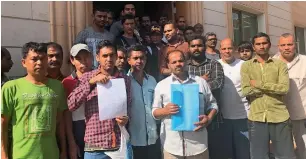  ?? Supplied photo ?? Workers of Al Wasita Emirates Catering Services in front of their accommodat­ion. —