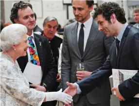  ??  ?? Charmed, ma’am: Michael Sheen shaking hands with the Queen